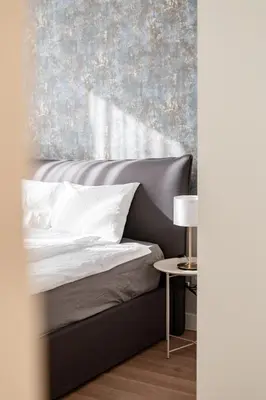 a bedroom with a bed with a wall at Aglaya Paris - Lux 2 Bedroom Apartment in Belgrade