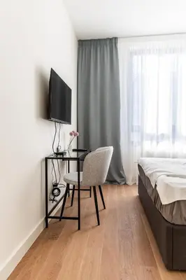 a bedroom with a desk and a bed and a chair at Aglaya Paris - Lux 2 Bedroom Apartment in Belgrade
