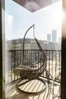 a swinging chair on a balcony with a view at Aglaya Paris - Lux 2 Bedroom Apartment in Belgrade