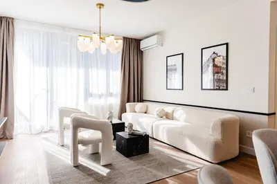 a living room with a white couch and chairs at Aglaya Paris - Lux 2 Bedroom Apartment in Belgrade