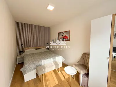 a bedroom with a bed and a chair at WATEREFRONT Apartments - Belgrade in Belgrade