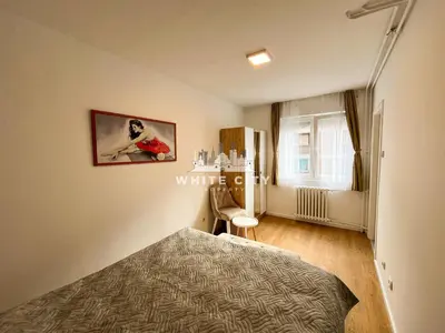 a bedroom with a bed and a table and a window at WATEREFRONT Apartments - Belgrade in Belgrade