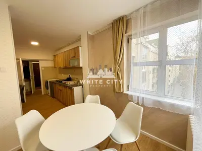 a white table and chairs in a kitchen with a window at WATEREFRONT Apartments - Belgrade in Belgrade