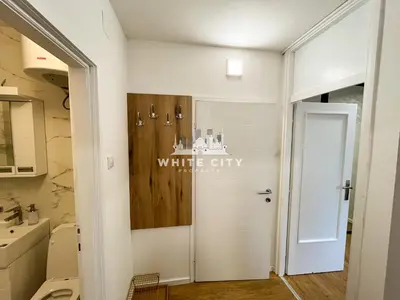 a bathroom with a white city sign on the door at WATEREFRONT Apartments - Belgrade in Belgrade