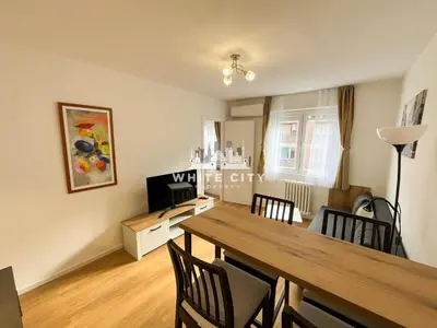a dining room and living room with a table and chairs at WATEREFRONT Apartments - Belgrade in Belgrade