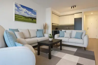 a living room with two couches and a table at Belgrade Waterfront - Art Apartments in Belgrade
