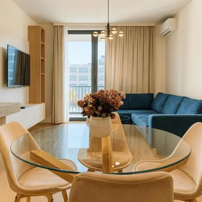 a living room with a glass table and chairs at Belgrade Waterfront - Art Apartments in Belgrade