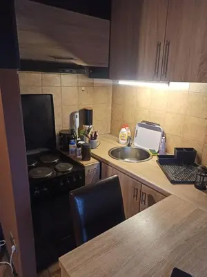 a kitchen with a stove top oven next to a sink at Stan u centru grada za 2 plus 1 osoba in Belgrade