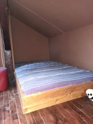 a bed in a room with a soccer ball on the floor at Stan u centru grada za 2 plus 1 osoba in Belgrade