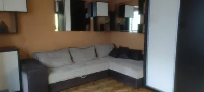 a living room with a couch and a mirror at Medo in Belgrade