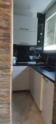 a kitchen with a black counter and a sink at Medo in Belgrade
