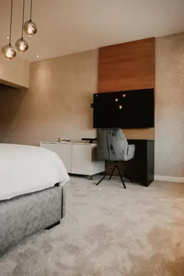 a bedroom with a bed and a flat screen tv at Diwine Spa House Fruška Gora in Irig