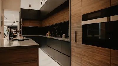 a kitchen with wooden cabinets and a microwave at Diwine Spa House Fruška Gora in Irig