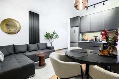 a living room with a couch and a table at Tasmajdan park, 15 minutes by walk to Knez Mihajlova Centar in Belgrade
