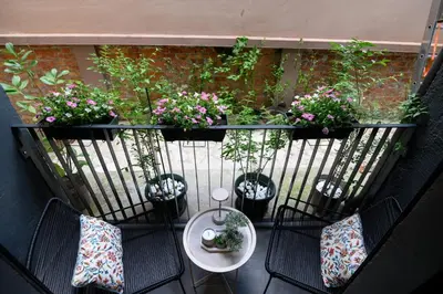 a balcony with chairs and a table and potted plants at Tasmajdan park, 15 minutes by walk to Knez Mihajlova Centar in Belgrade