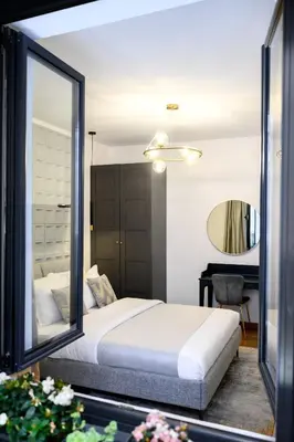 a bedroom with a bed and a mirror at Tasmajdan park, 15 minutes by walk to Knez Mihajlova Centar in Belgrade