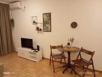 a living room with a table and a tv at Apartman Vuk in Obrenovac