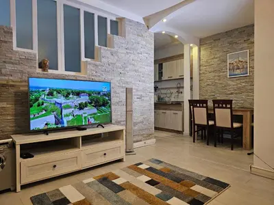 a living room with a flat screen tv on a stand at Zante Apartment in Belgrade
