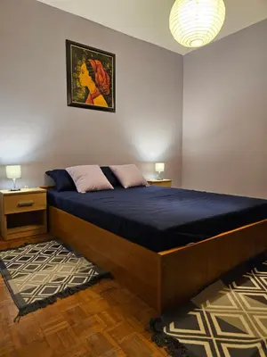 a bedroom with a large bed with a blue mattress at Zante Apartment in Belgrade