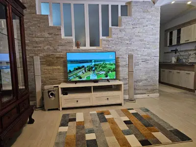 a living room with a flat screen tv on a stand at Zante Apartment in Belgrade