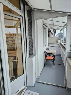a balcony with a table and a chair on it at Zante Apartment in Belgrade