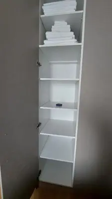 a white closet with white shelves and white towels at Belgrade Waterfront Terra Apartments in Belgrade