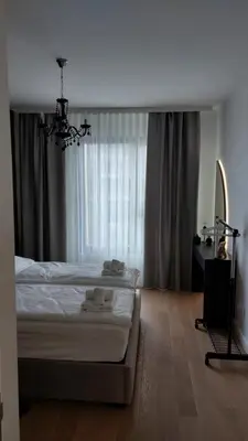 a bedroom with a large bed and a window at Belgrade Waterfront Terra Apartments in Belgrade