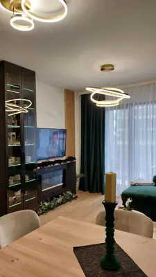 a living room with a television and a table with chairs at Belgrade Waterfront Terra Apartments in Belgrade