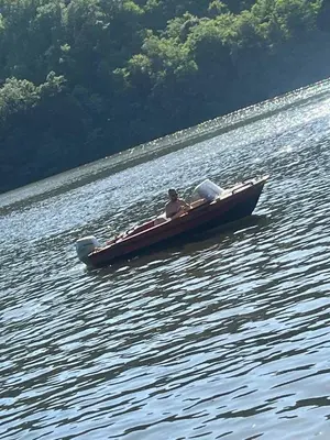 a man in a boat on a body of water at Vikendica Emily in Kovin