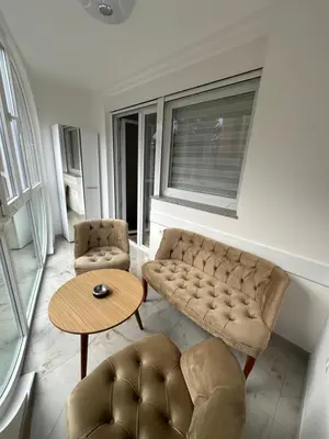 a living room with a couch and a table at Apartman Aranđelovac2 in Arandjelovac