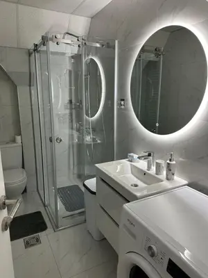 a white bathroom with a shower and a sink at Apartman Aranđelovac2 in Arandjelovac