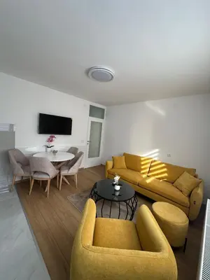 a living room with two couches and a table at Apartman Aranđelovac2 in Arandjelovac