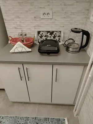a kitchen counter with white cabinets and a blender on it at Star Apartment Belgrade 1 in Belgrade