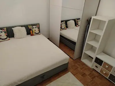 a small room with two beds and a book shelf at Star Apartment Belgrade 1 in Belgrade