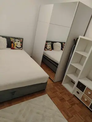 a small bedroom with two beds and a mirror at Star Apartment Belgrade 1 in Belgrade