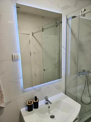 a bathroom with a sink and a glass shower at MiS Lux in Mladenovac