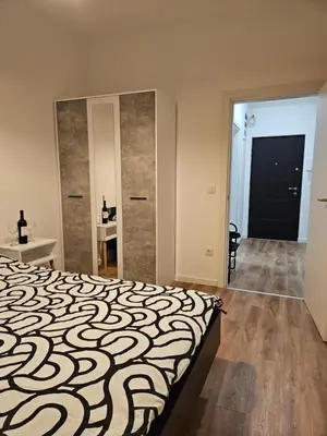 a bedroom with a large bed with a large mirror at MiS Lux in Mladenovac