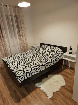 a bedroom with a bed with a black and white bedspread at MiS Lux in Mladenovac