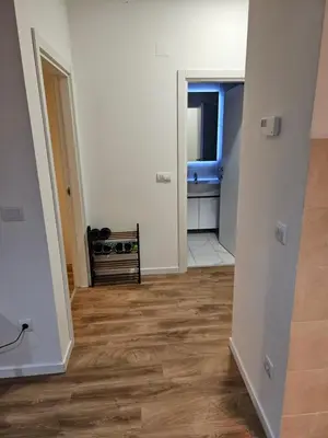 an empty room with a wooden floor and a hallway at MiS Lux in Mladenovac