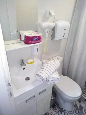 a white bathroom with a sink and a toilet at Zora in Žarkovo