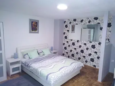 a small bedroom with a bed and a mirror at Zora in Žarkovo