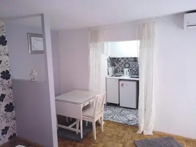 a small kitchen with a desk and a table at Zora in Žarkovo