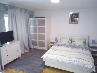 a bedroom with a white bed and a tv at Zora in Žarkovo