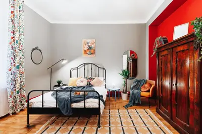 a bedroom with a bed and a red wall at Air Hockey Joy Old Town Heart in Belgrade