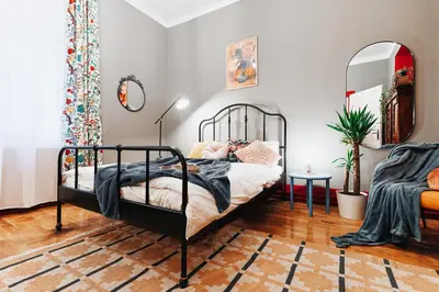 a bedroom with a black bed with a mirror at Air Hockey Joy Old Town Heart in Belgrade