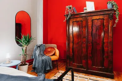 a room with a large wooden cabinet and a chair at Air Hockey Joy Old Town Heart in Belgrade