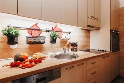a kitchen with a sink and vegetables on a counter at Air Hockey Joy Old Town Heart in Belgrade