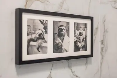 a framed picture of three dogs on a wall at Capitol Apartment Belgrade in Belgrade