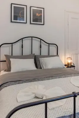 a bed with two white towels on top of it at Capitol Apartment Belgrade in Belgrade