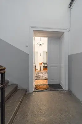 a hallway with a stairway leading to a room at Capitol Apartment Belgrade in Belgrade
